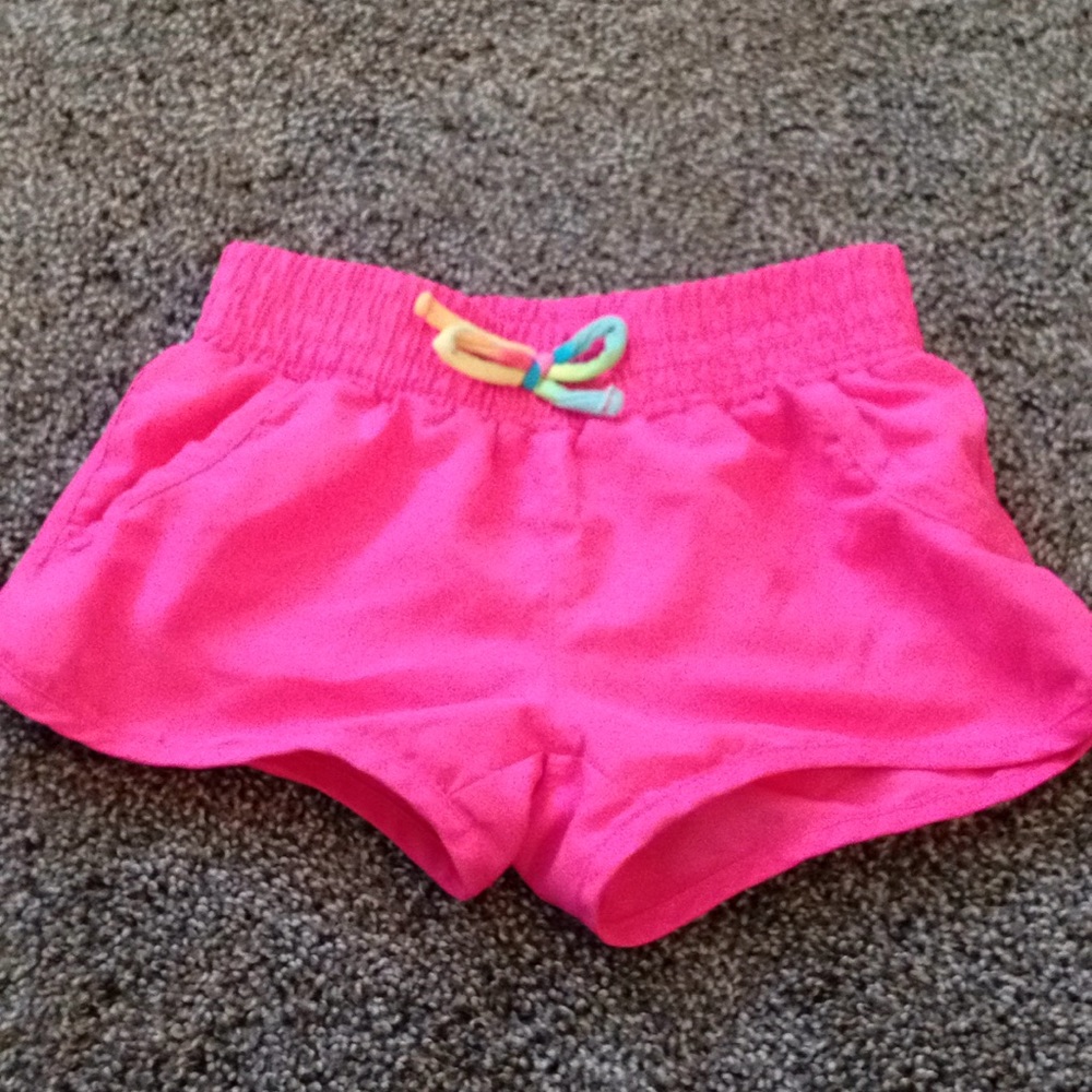 Hot pink swimming shorts.